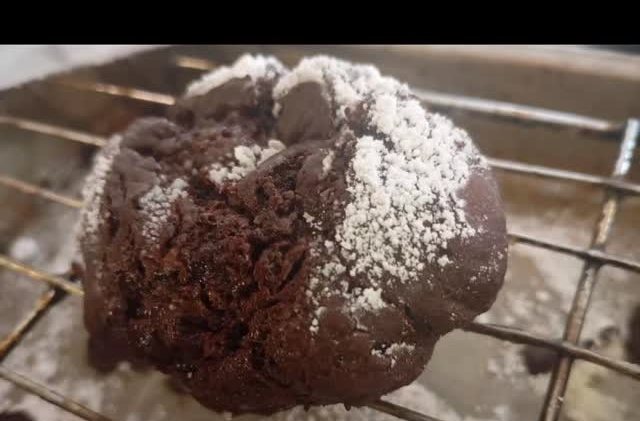 Double chocolate crinkle cookie on a cooling rack