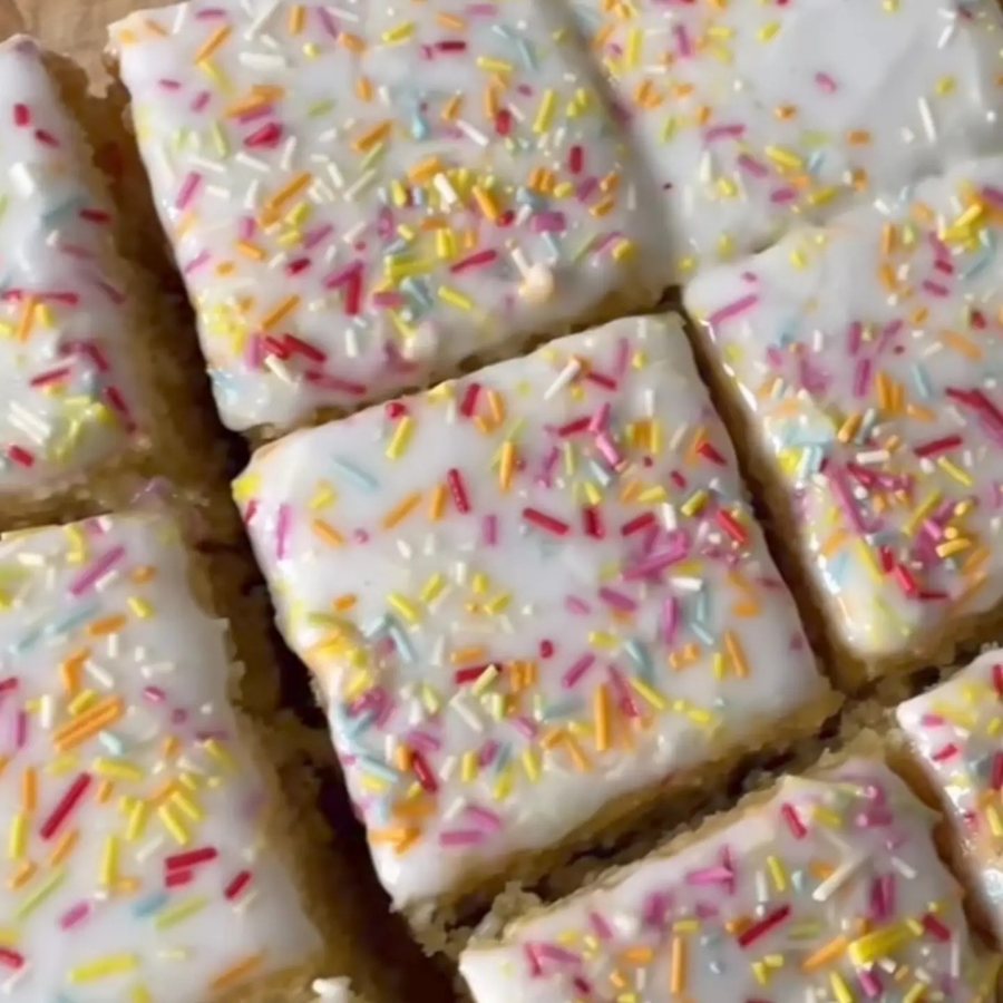 Vanilla traybake with white icing and rainbow sprinkles